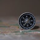 A detailed image of a compass on a map, symbolizing navigation and exploration.